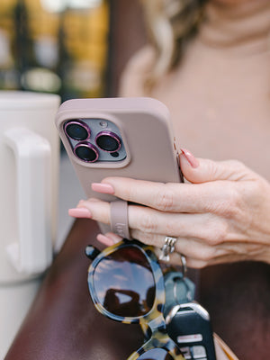 A woman holding a Stone Loopy Case. || feature-media