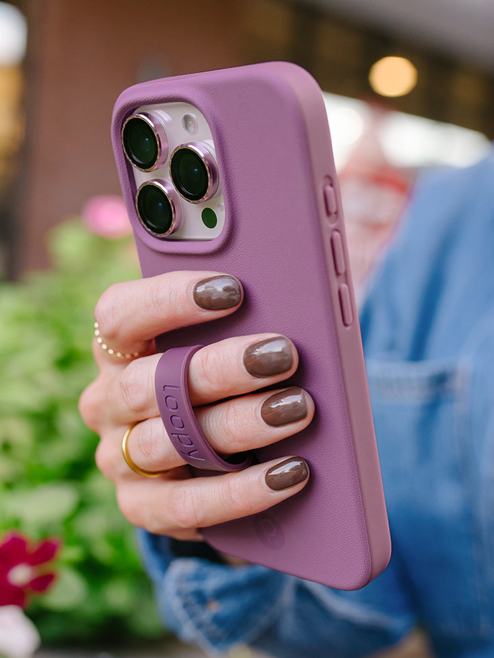 A woman holding a Dusty Plum Loopy Case. || feature-media