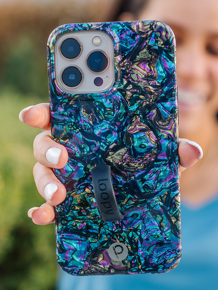A woman holding an Abalone Loopy Case. || feature-media