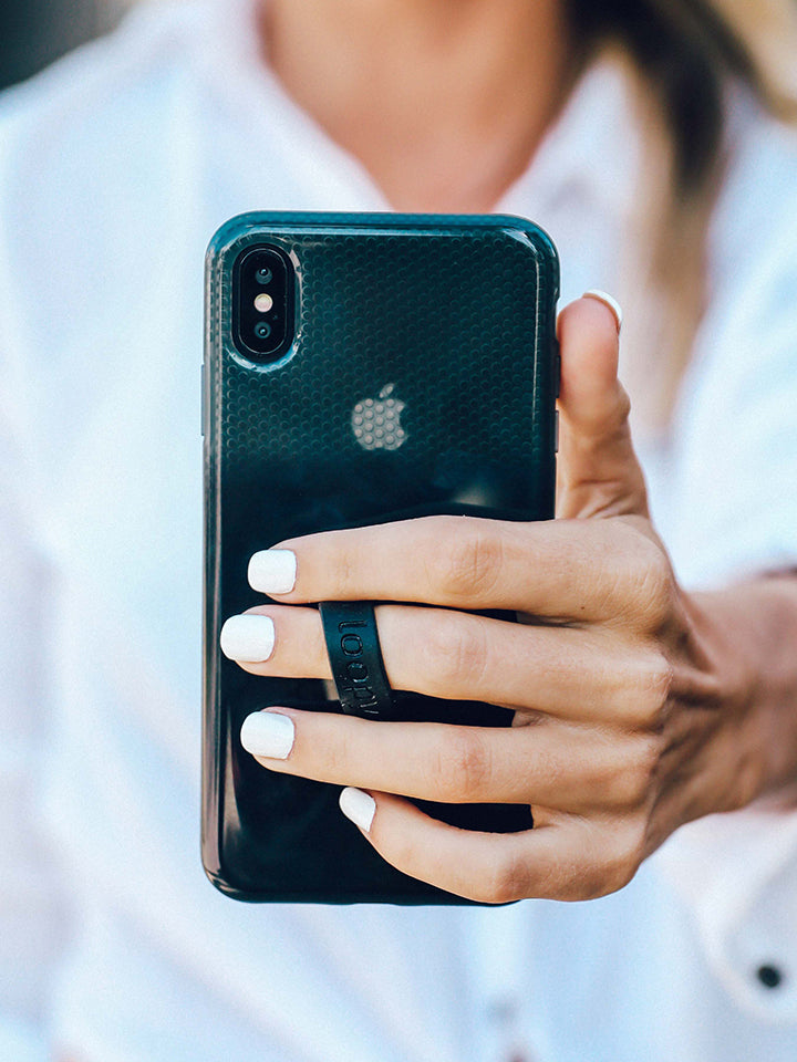 A woman holding a Black Ombre Loopy Case.