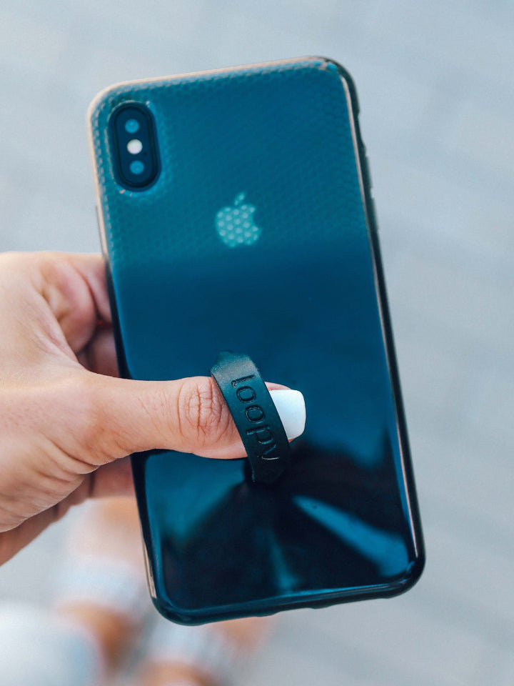 A woman holding a Black Ombre Loopy Case.