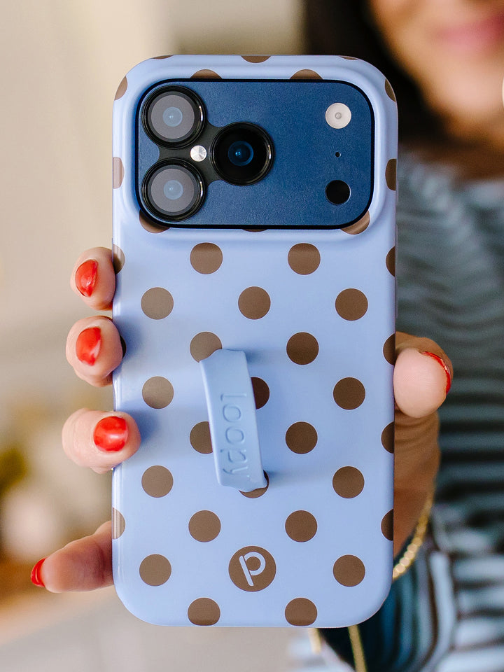 A woman holding a Blue Polka Dots Loopy Case. || feature-media