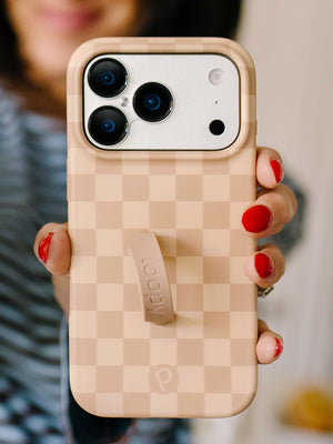 A woman holding a Caramel Checkered Loopy Case. || feature-media