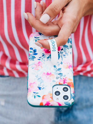  A woman holding a Gardenia Loopy Case.|| feature-media