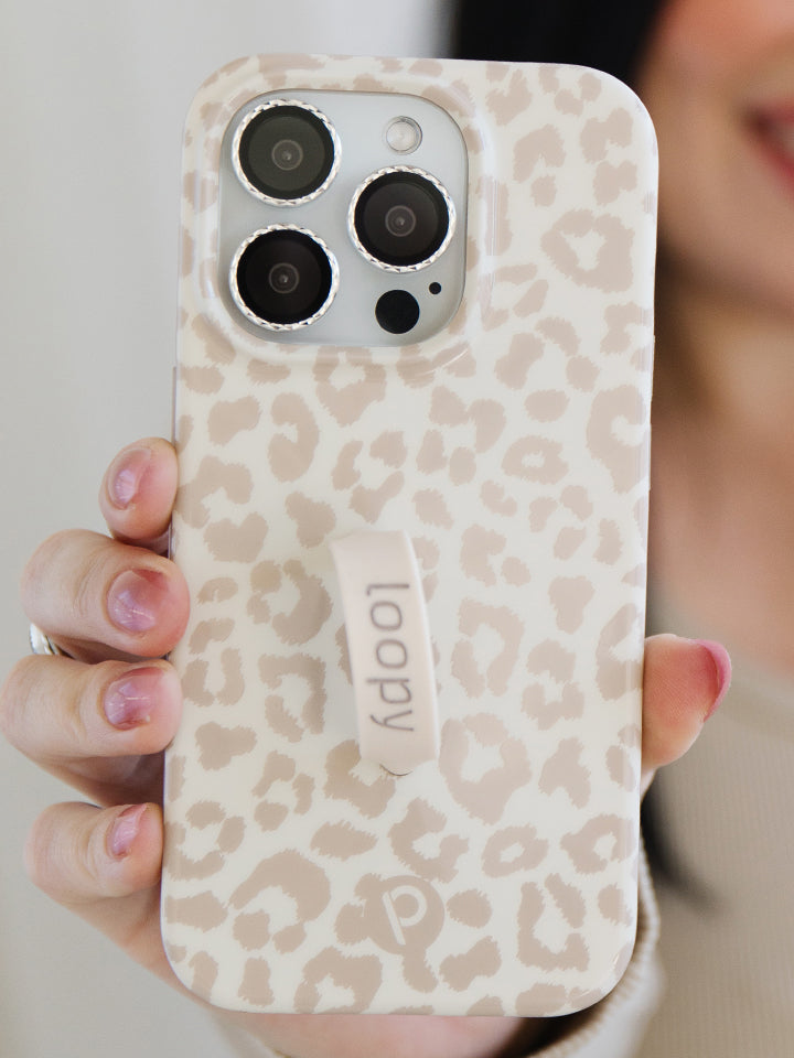 A woman holding a Taupe Leopard Loopy Case. 