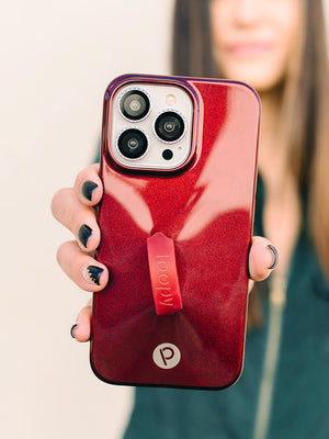 A woman holding a Maroon Shimmer Loopy Case.|| feature-media