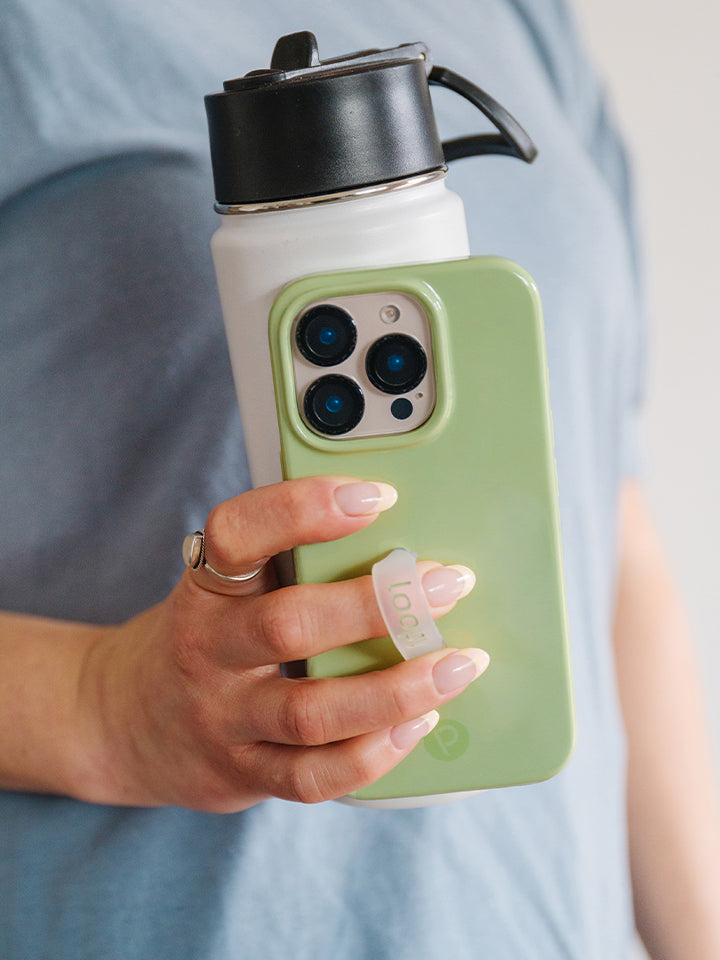 A woman holding a Matcha Green Loopy Case. || feature-media