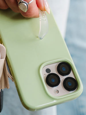 A woman holding a Matcha Green Loopy Case. || feature-media