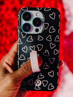 A woman holding a Midnight Hearts Loopy Case. || feature-media