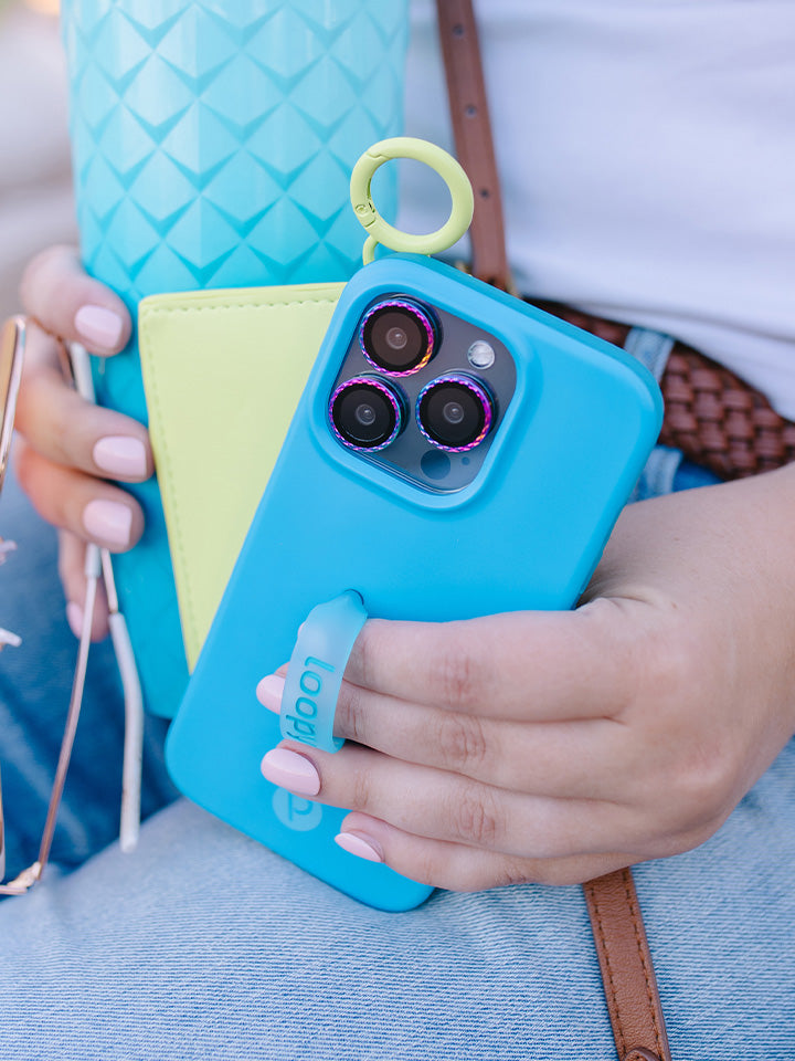 A woman holding a Neon Cyan Loopy Case.