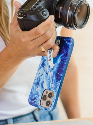 A woman holding an Ocean Loopy Case.|| feature-media