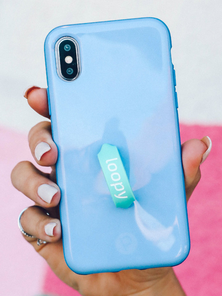 A woman holding a Periwinkle Loopy Case. 