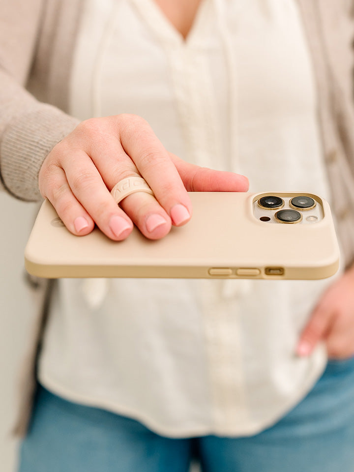A woman holding a Sandstone Loopy Case. || feature-media