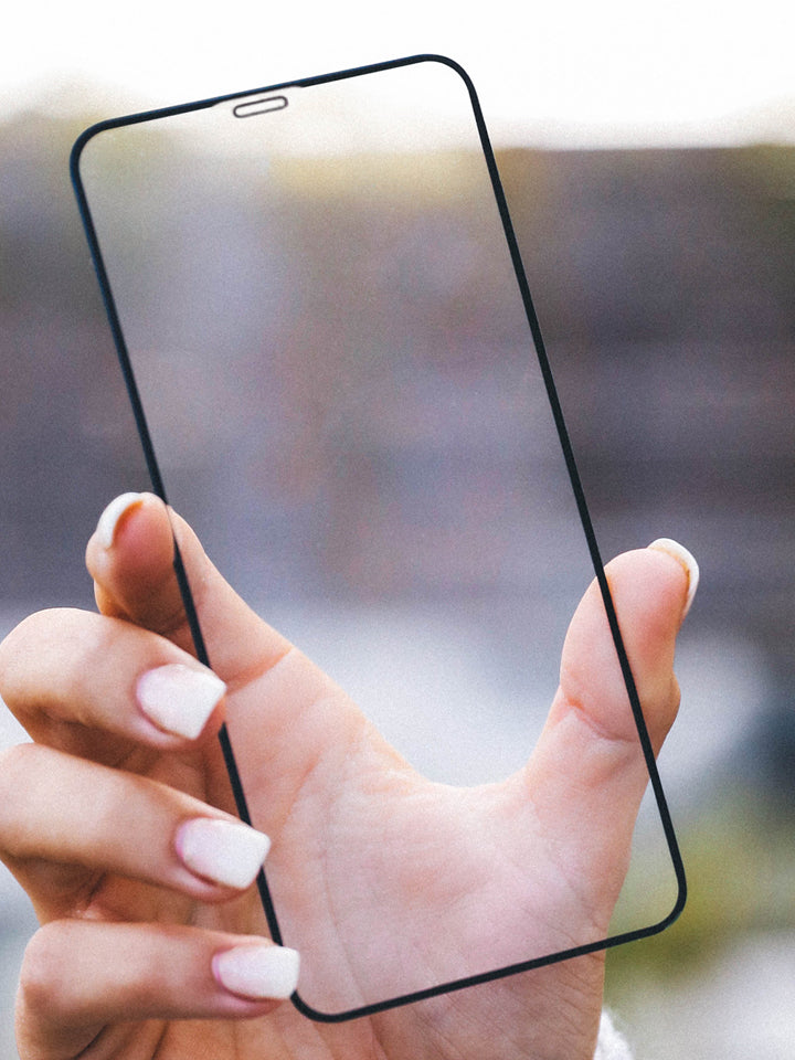 A woman holding a Loopy Cases Clear Screen Tempered Glass. 
