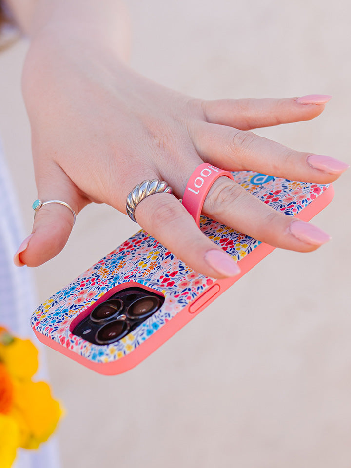 A woman holding a Spring Meadow Loopy Case. || feature-media