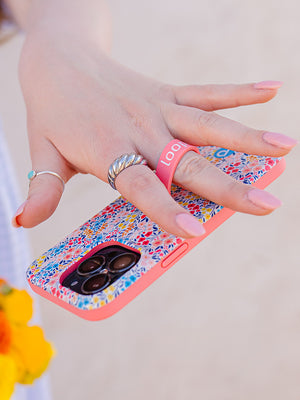 A woman holding a Spring Meadow Loopy Case. || feature-media