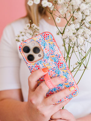 A woman holding a Spring Meadow Loopy Case. || feature-media