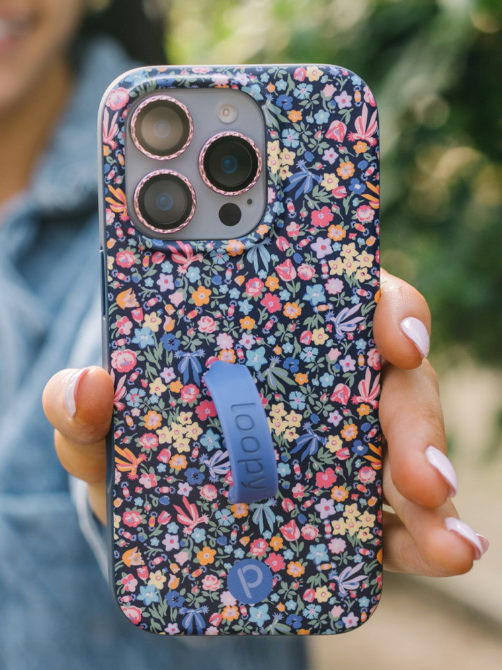A woman holding a Whimsy Garden Loopy Case. || feature-media