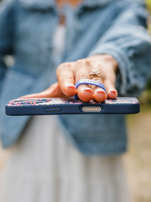 A woman holding a Whimsy Garden Loopy Case. || feature-media