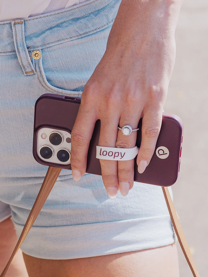 A woman holding a Wine Loopy Case.  || feature-media
