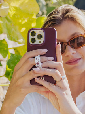 A woman holding a Wine Loopy Case.  || feature-media
