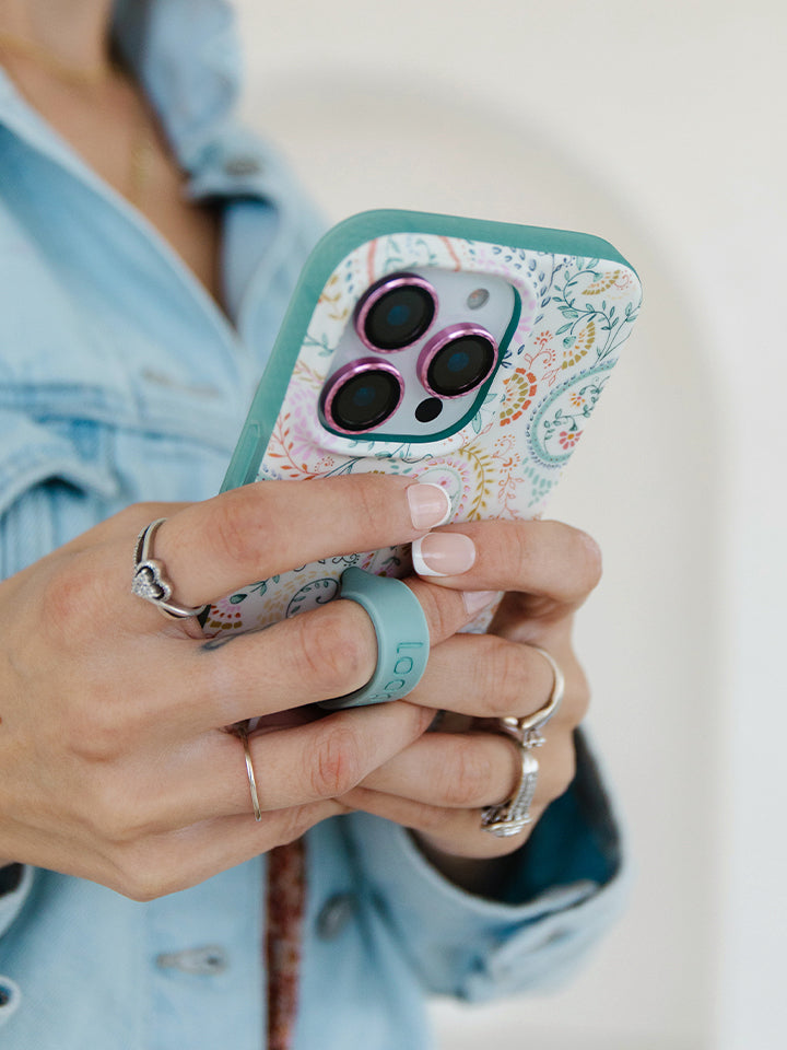 A woman holding a Painted Paisley Loopy Case. || feature-media