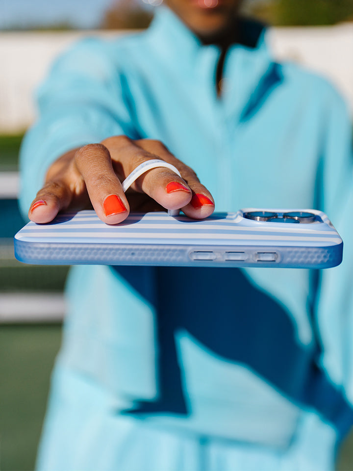 A woman holding a Blue Stripes Loopy Case. || feature-media