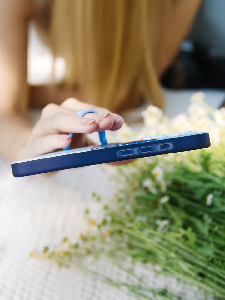 A woman holding a Bandana Blues Loopy Case. || feature-media