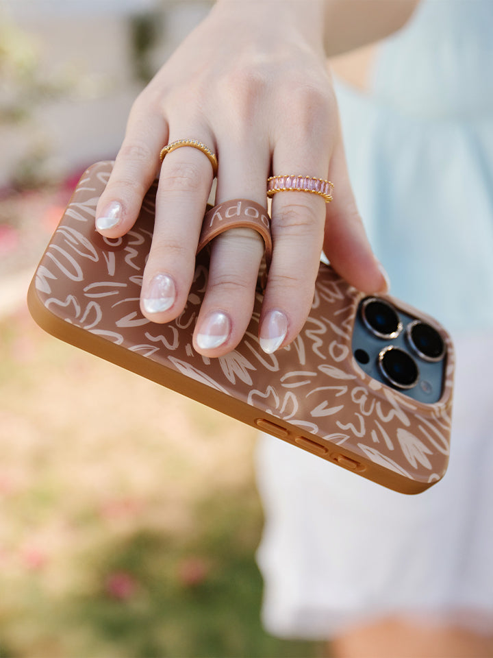 A woman holding a Sienna Sketches Loopy Case. || feature-media