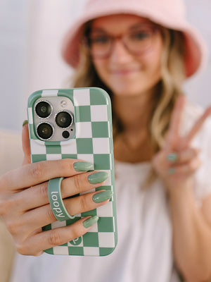 A woman holding a Green Checkered Loopy Case. || feature-media