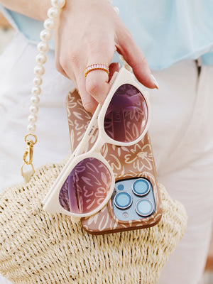 A woman holding a Sienna Sketches Loopy Case. || feature-media