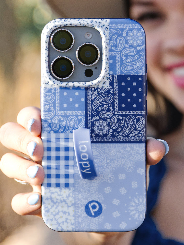 A woman holding a Bandana Blues Loopy Case. || feature-media