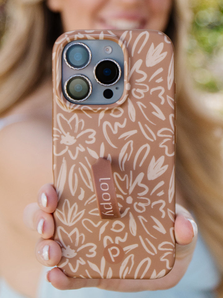 A woman holding a Sienna Sketches Loopy Case. || feature-media