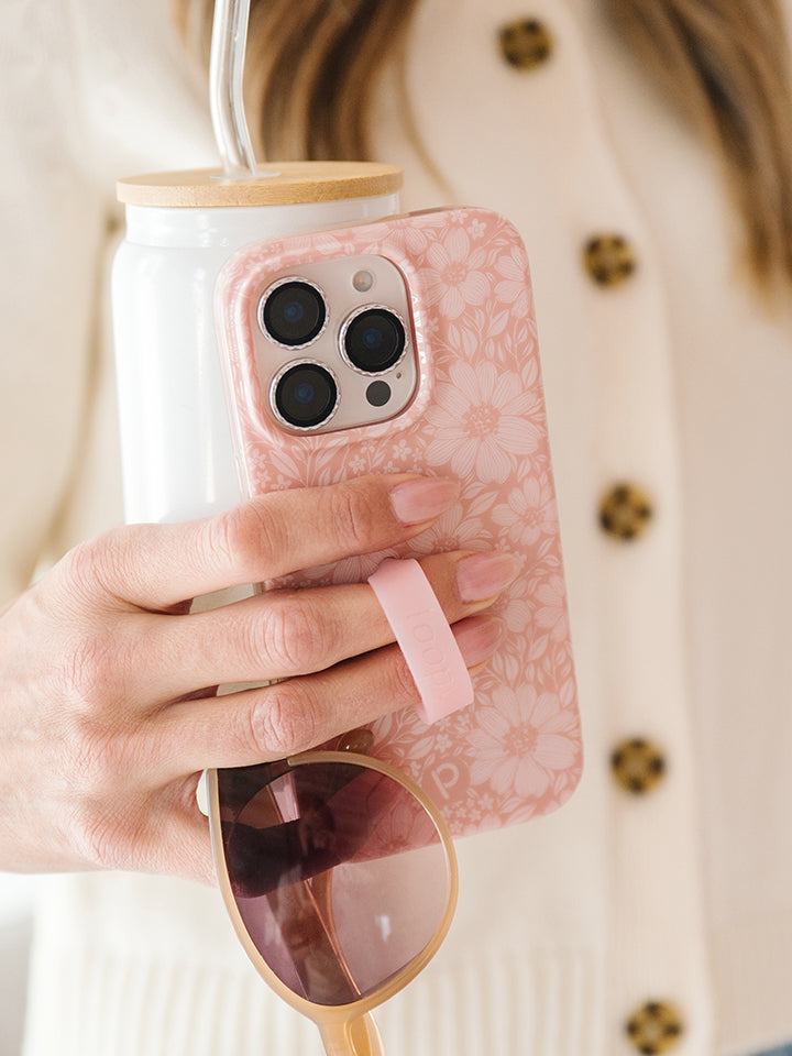 A woman holding a Rosewood Meadow Loopy Case. || feature-media