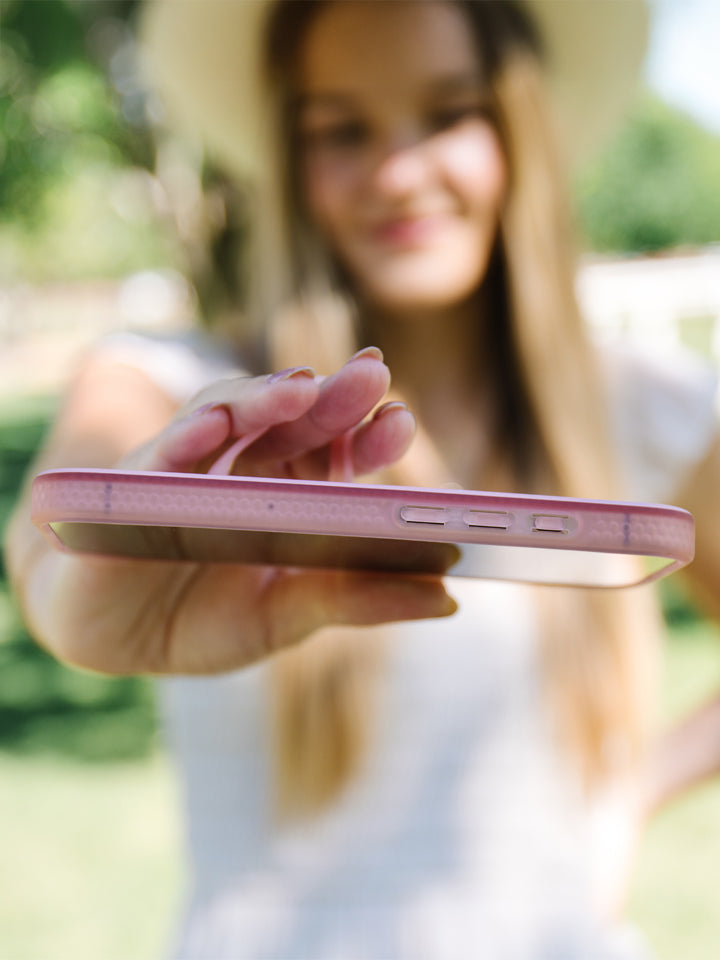 A woman holding a Cowgirl Charm Loopy Case. || feature-media