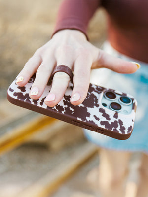 A woman holding a Pony Up Loopy Case. || feature-media