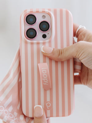 A woman holding a Terracotta Stripes Loopy Case. || feature-media