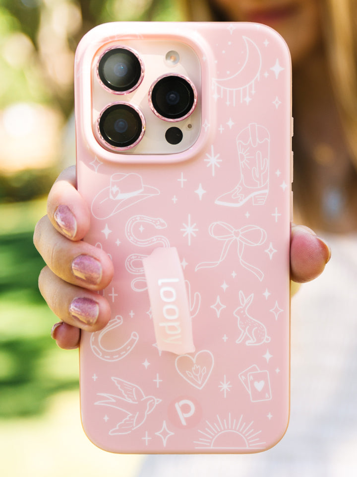 A woman holding a Cowgirl Charm Loopy Case. || feature-media