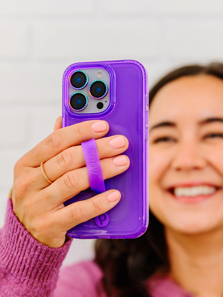 A woman holding a Clear Neon Purple Loopy Case. || feature-media
