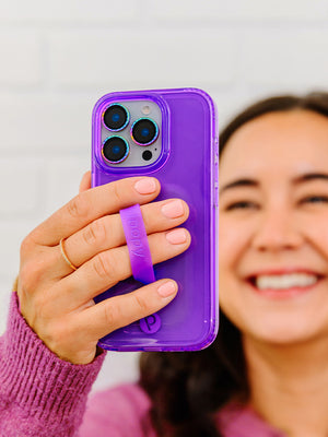 A woman holding a Clear Neon Purple Loopy Case. || feature-media
