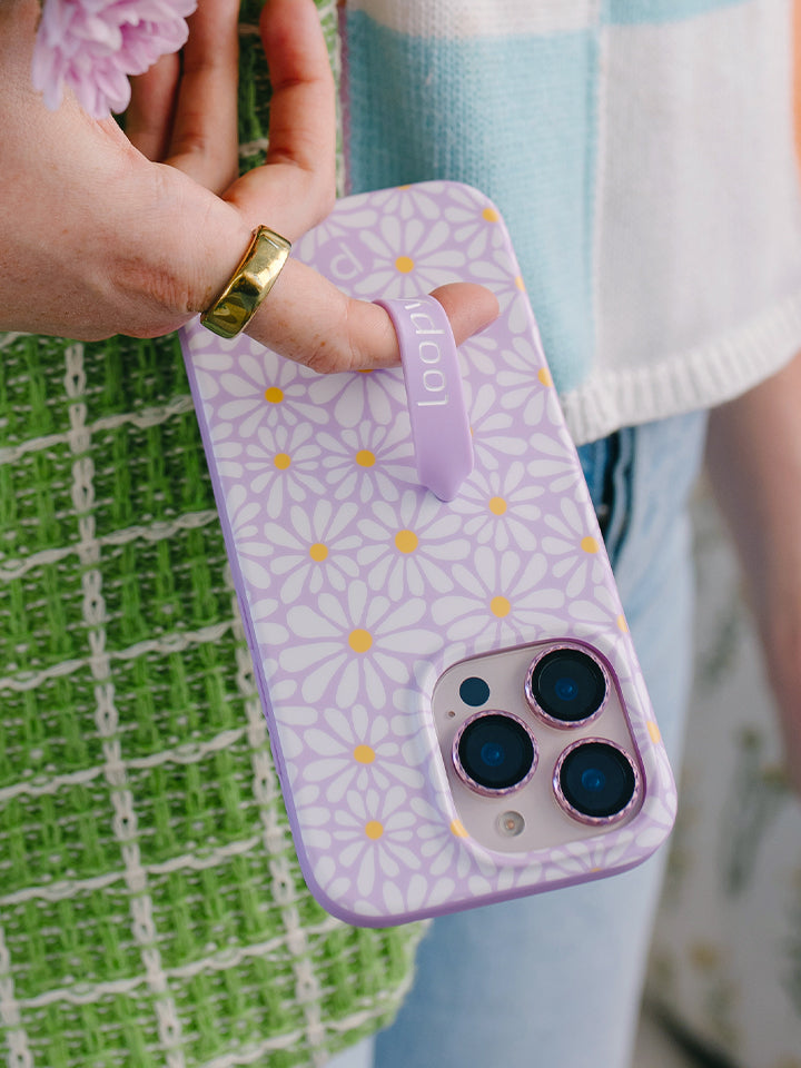 A woman holding a Daisy Daze Loopy Case. || feature-media