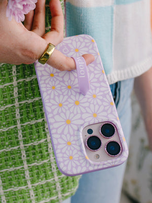 A woman holding a Daisy Daze Loopy Case. || feature-media