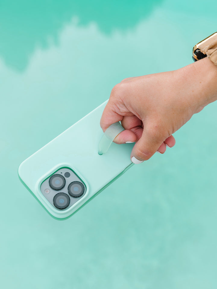 A woman holding a Mint Splash Loopy Case. || feature-media