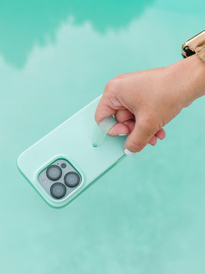 A woman holding a Mint Splash Loopy Case. || feature-media