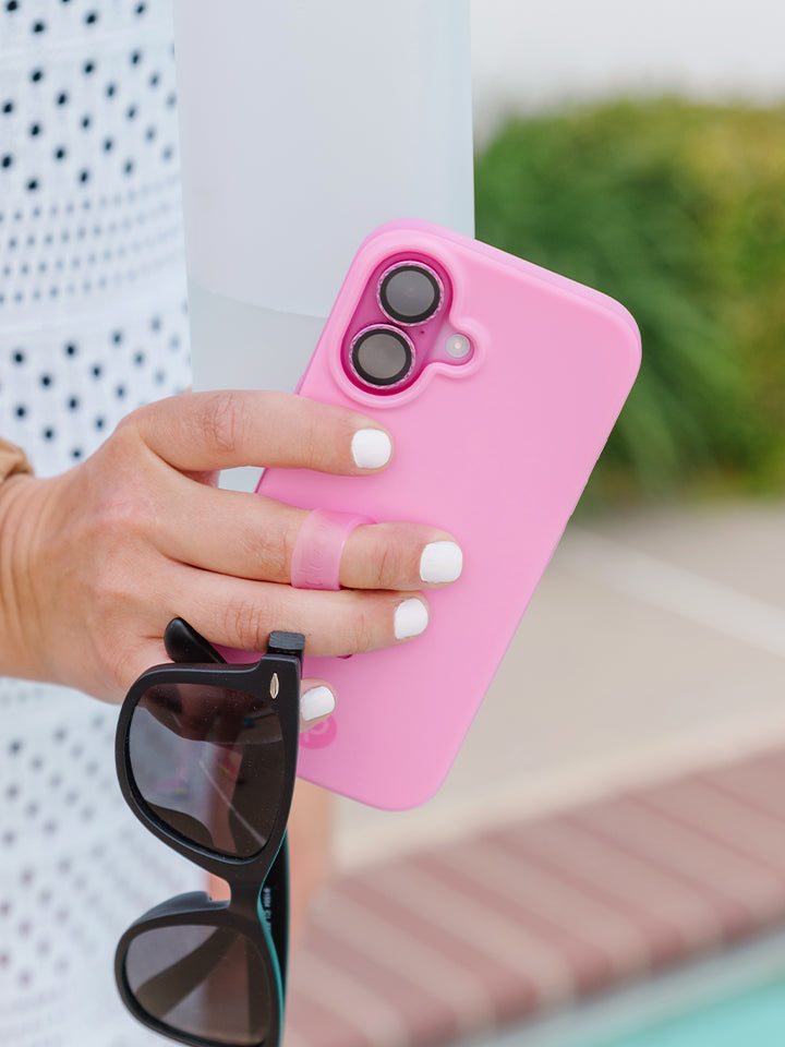 A woman holding a Berry Pink Loopy Case. || feature-media