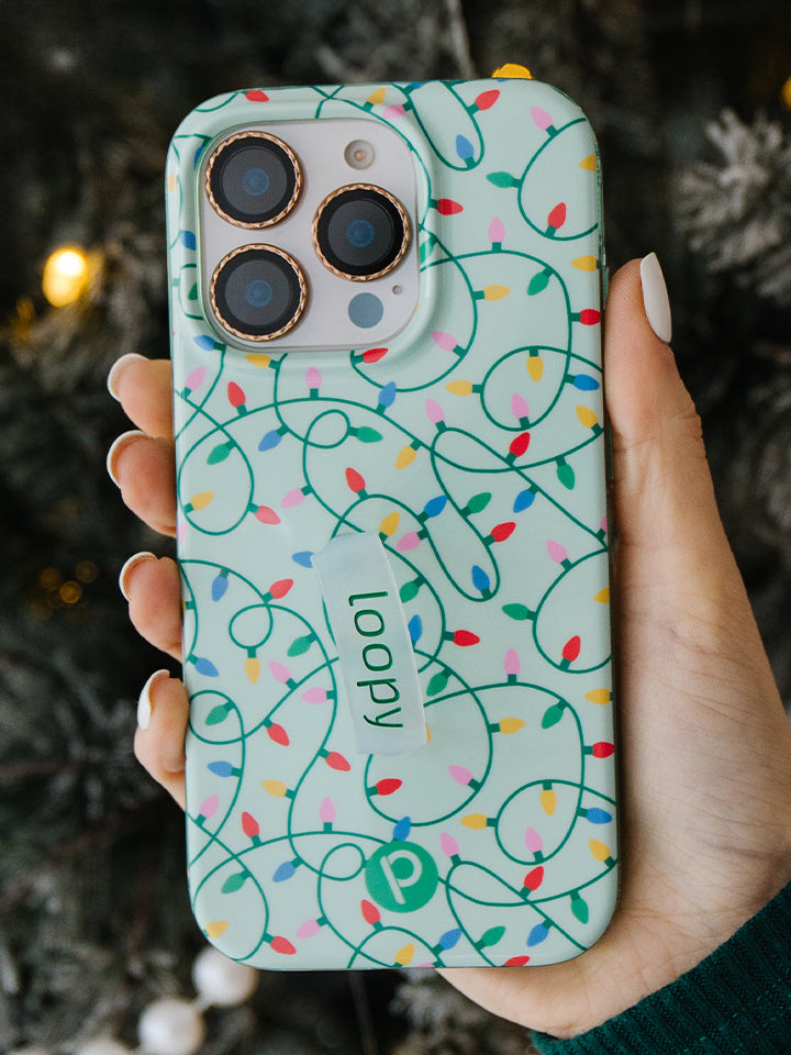 A woman holding a Merry and Bright Loopy Case. || feature-media