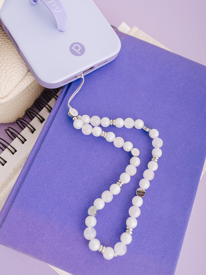 A White Aura Loopy Cases Wristlet attached to a Lilac Loopy Case.