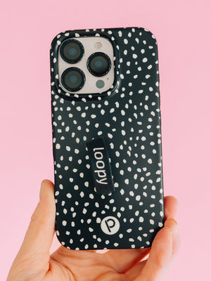 A woman holding a Noir Dots Loopy Case. || feature-media