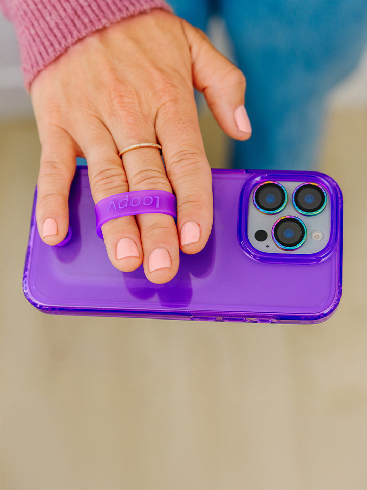 A woman holding a Clear Neon Purple Loopy Case. || feature-media
