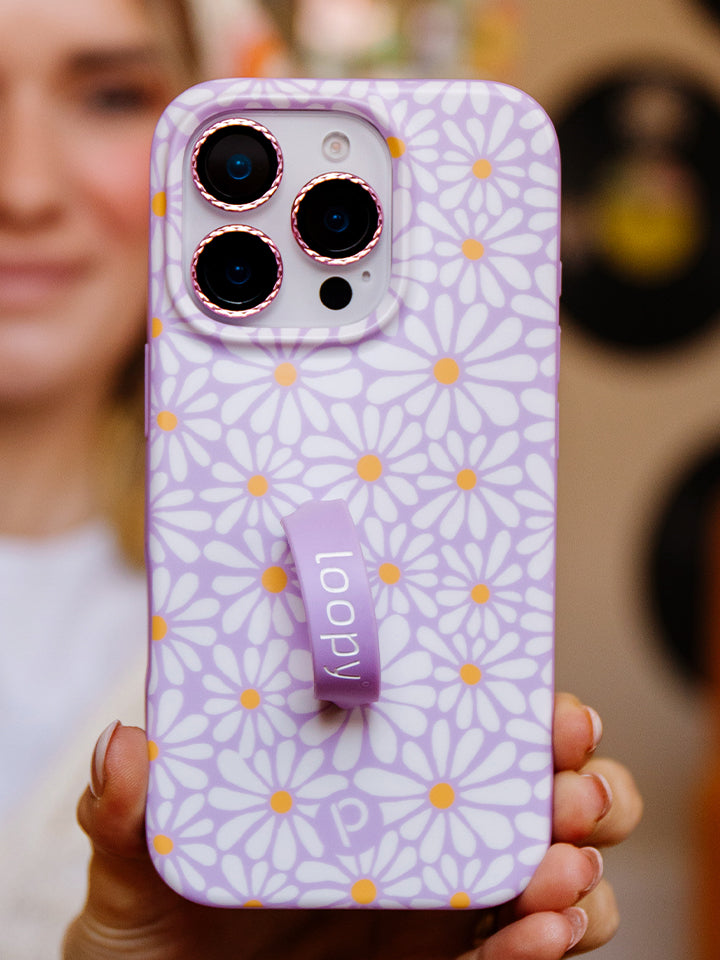 A woman holding a Daisy Daze Loopy Case. || feature-media